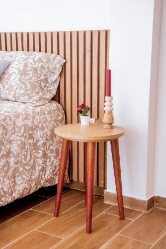 a table with a candle on it next to a bed at Hogar de Olas Huanchaco in Huanchaco
