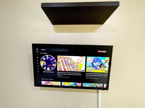 a flat screen tv hanging on a wall at Ecuabook OmniHospital Torre Sol 702 in Guayaquil