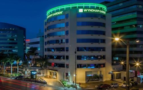 a building with a green sign on top of it at Ecuabook OmniHospital Torre Sol 702 in Guayaquil