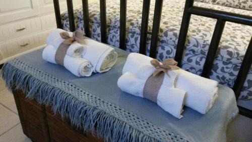 two rolls of towels sitting on a crib at Donna Isabella in Trani
