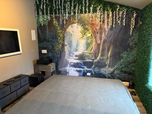 a bedroom with a mural of a waterfall at The Marlowe, A Couples Getaway in Chicago
