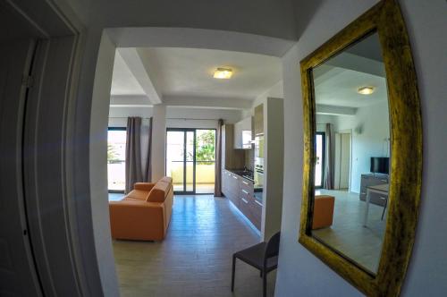 a living room with a mirror and a couch at Surf House Cabo Verde in Santa Maria