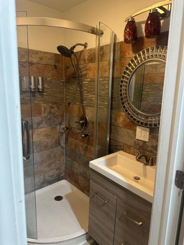 a bathroom with a shower and a sink at The Marlowe, A Couples Getaway in Chicago
