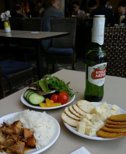 two plates of food with rice and a bottle of sauce at Maple Tree Inn in Sunnyvale