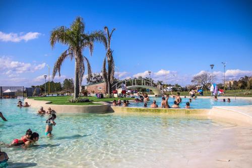 a group of people in the water at a swimming pool at IRUPÉ APART HOTEL in Federación