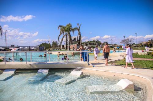 a group of people in a swimming pool at IRUPÉ APART HOTEL in Federación