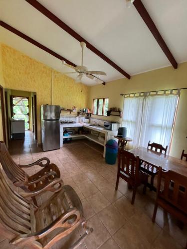 a large kitchen with a table and a dining room at Costa Rica Getaway in Jacó