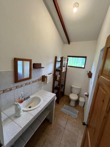 a bathroom with a sink and a toilet at Costa Rica Getaway in Jacó