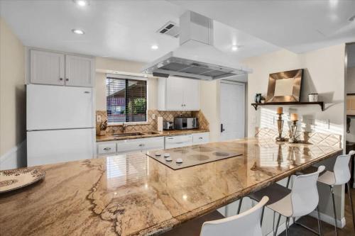 a kitchen with a large marble counter top at PD Resorter 2BR with Golf course views in Palm Desert