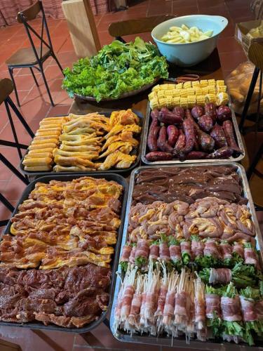 a buffet of different types of food on a table at Mây home Trạm Tấu lều khách sạn in Ya Ló