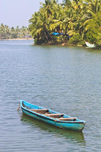 a blue boat sitting on a body of water at Paradise Lagoon in Kalyānpur