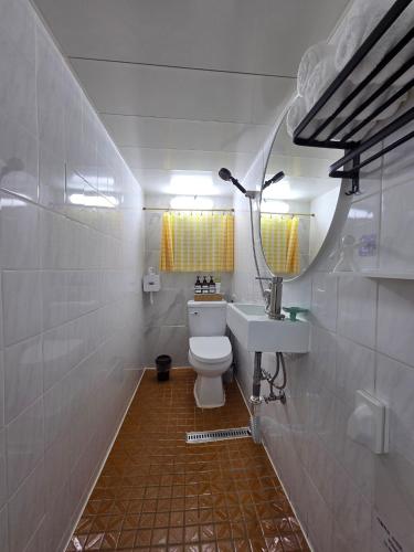 a bathroom with a toilet and a sink and a mirror at Dodam Stay in Seoul
