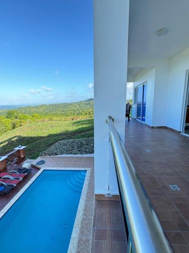 a swimming pool with a slide in a building at Beautiful ocean and mountain view villa in Gaspar Hernández