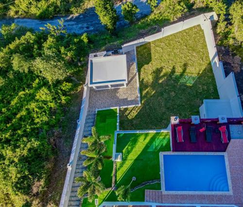 an overhead view of a house with a swimming pool at Beautiful ocean and mountain view villa in Gaspar Hernández