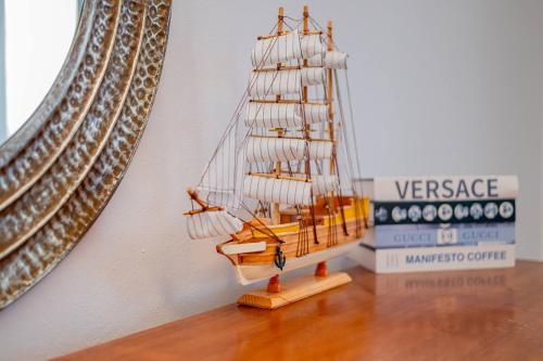 a wooden ship on a table next to a mirror at Beautiful ocean and mountain view villa in Gaspar Hernández