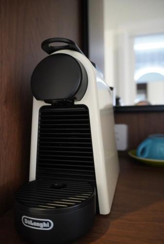 a toaster sitting on top of a wooden table at Tall Timbers Hotel in Ourimbah