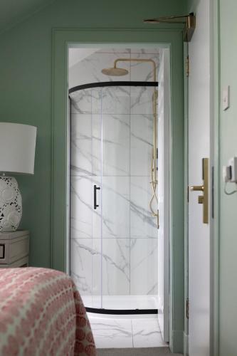 a bedroom with a door leading to a white room at The Broughton Townhouse in Edinburgh