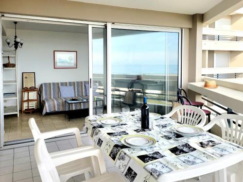 une salle à manger avec une table et des chaises et un balcon dans l'établissement Canet-en-Roussillon - T2 cabine - 6 pers - Garage fermé - WIFI - FR-1-794-126, à Canet