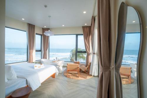 a bedroom with a bed and views of the ocean at Sunsea House-Đá Đĩa Phú Yên in Tuy An
