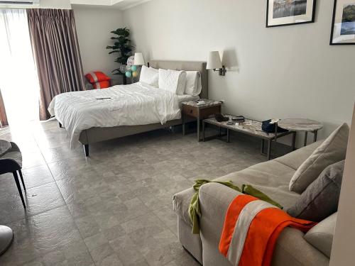 a living room with a bed and a couch at 1106 LaGrande2 11floor rooftop swiming angeles Walking street in Angeles