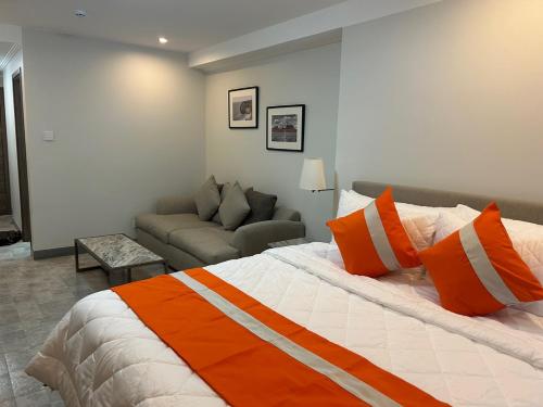 a bedroom with a large bed and a couch at 1106 LaGrande2 11floor rooftop swiming angeles Walking street in Angeles