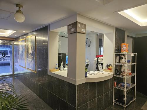 a room with a store with a counter with mirrors at Hotel Castle in Gwangmyeong