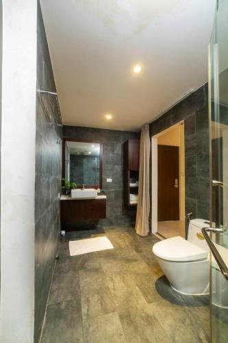 a bathroom with a toilet and a sink at The Yen Ocean Villa - Private An Bang Beach Villa in An Bang