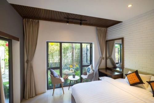 a bedroom with a bed and a large window at The Yen Ocean Villa - Private An Bang Beach Villa in An Bang