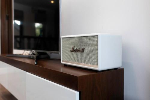 a television sitting on top of a wooden table at The Yen Ocean Villa - Private An Bang Beach Villa in An Bang