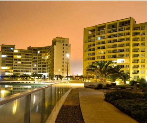 a view of a city at night with buildings at LA SERENA- Laguna del Mar in La Serena