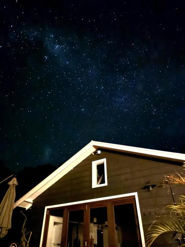 a house with a window and a star filled sky at Braelee Bower in Rollands Plains