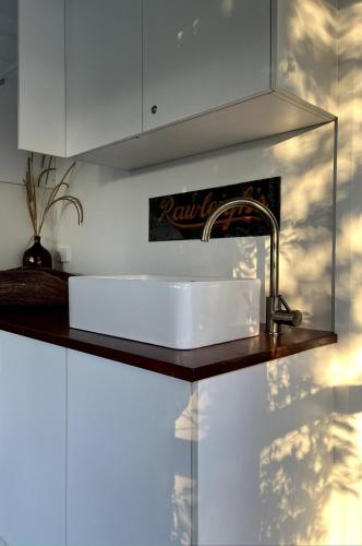 a white sink in a kitchen with a counter at Braelee Bower in Rollands Plains