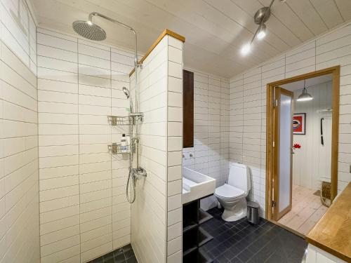 a bathroom with a toilet and a sink and a shower at Family House With Large Plot Near The Water in Vätö
