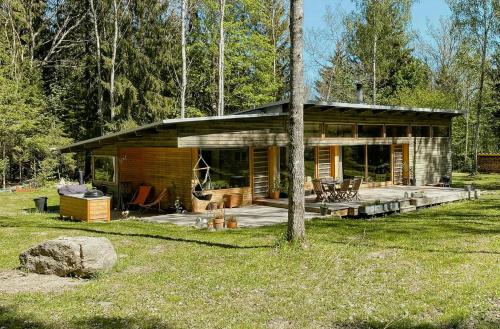 a log cabin in the middle of a forest at Family House With Large Plot Near The Water in Vätö