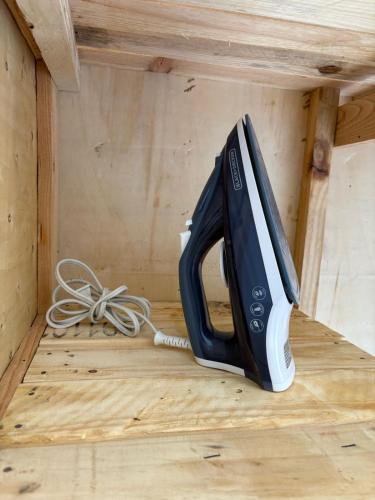 a black and white appliance sitting on a wooden floor at Santa Noche Loft & Spa in San Miguel de Allende