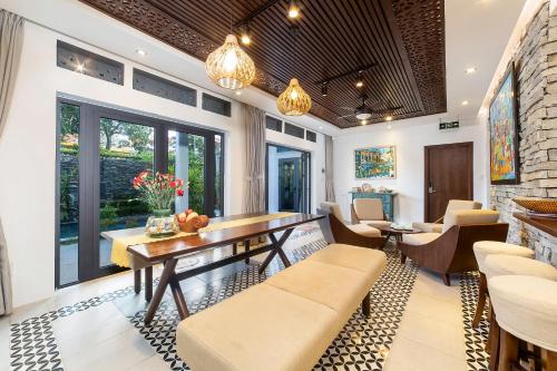 a dining room with a table and chairs at The Yen Ocean Villa - Private An Bang Beach Villa in An Bang