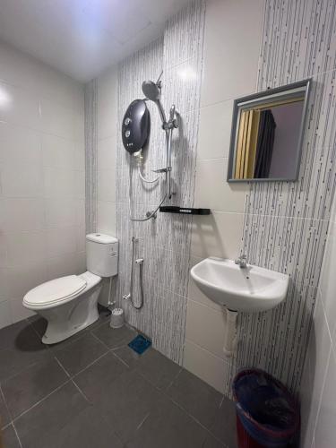 a bathroom with a toilet and a sink at RedHouse Sky Garden Klabang in Ipoh