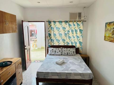 a bedroom with a bed in a room at GJEs Lodge and guest house in Basdiot
