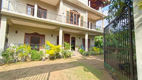 an external view of a house with a gate at Sunrise Relax Inn in Beruwala