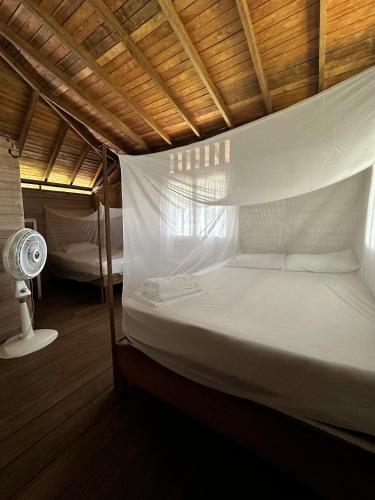 El ValleにあるHotel Don Aíのファン付きの客室の白いベッド1台分です。