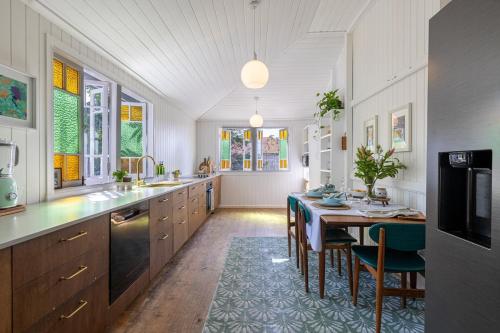 a kitchen with a table and a dining room at SEASIDE HAVEN Luxe Four BR Oasis with Plunge Pool in Brisbane