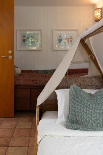 a bedroom with a bed with a wooden canopy at SEASIDE HAVEN Luxe Four BR Oasis with Plunge Pool in Brisbane