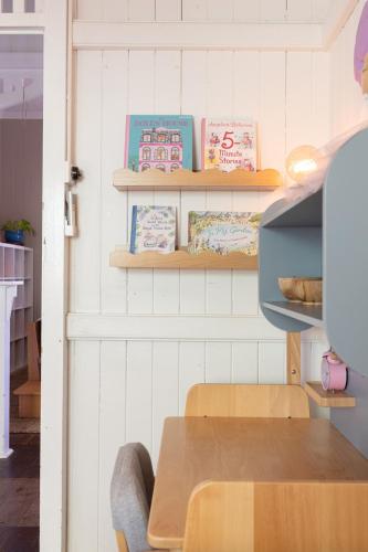 a room with a table and shelves with books at SEASIDE HAVEN Luxe Four BR Oasis with Plunge Pool in Brisbane