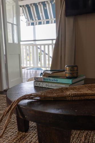 two books sitting on top of a wooden table at SEASIDE HAVEN Luxe Four BR Oasis with Plunge Pool in Brisbane