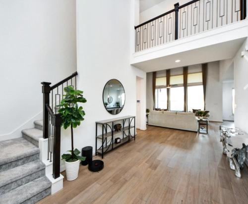 a large living room with stairs and a mirror at Prívate Room In Cypress in Hot Wells