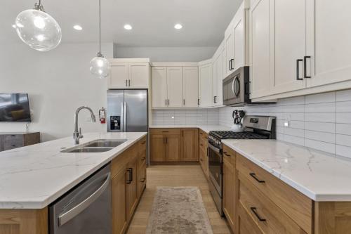 a kitchen with white appliances and wooden cabinets at Villa #12 at Bloomington Country Club townhouse in St. George