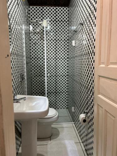 a bathroom with a toilet and a sink and a shower at La Mar Paraty Hospedaria 04 in Paraty