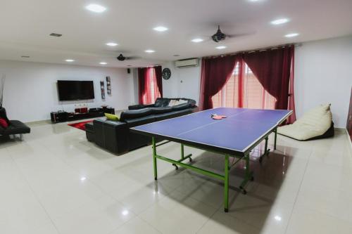 a living room with a table and a couch at Chic 6BR Home Private Rooftop Garden Kemensah KL in Ampang