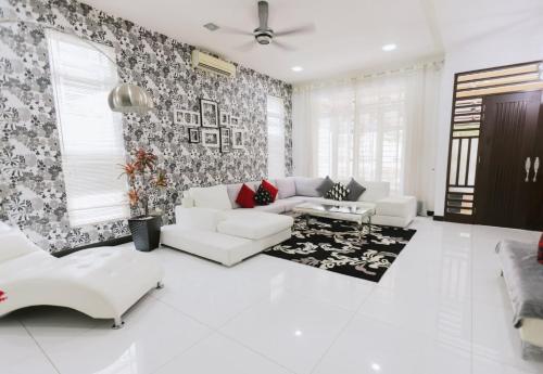a living room with a couch and a table at Chic 6BR Home Private Rooftop Garden Kemensah KL in Ampang