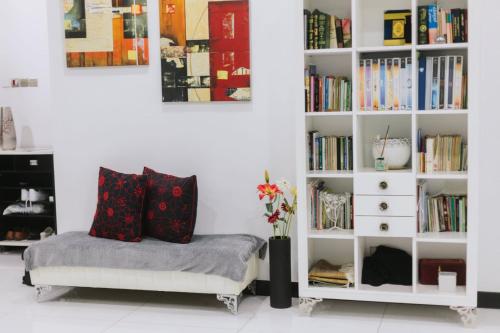 a room with a book shelf filled with books at Chic 6BR Home Private Rooftop Garden Kemensah KL in Ampang